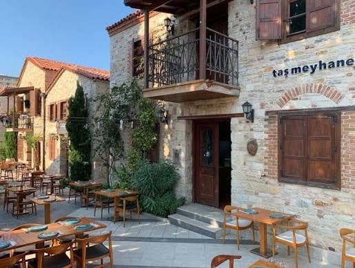 Restored Ottoman-era stone tavern in the Kuşadası Old Town Tanneries district with hand-cut tables in a quiet courtyard, eight minutes from the cruise port