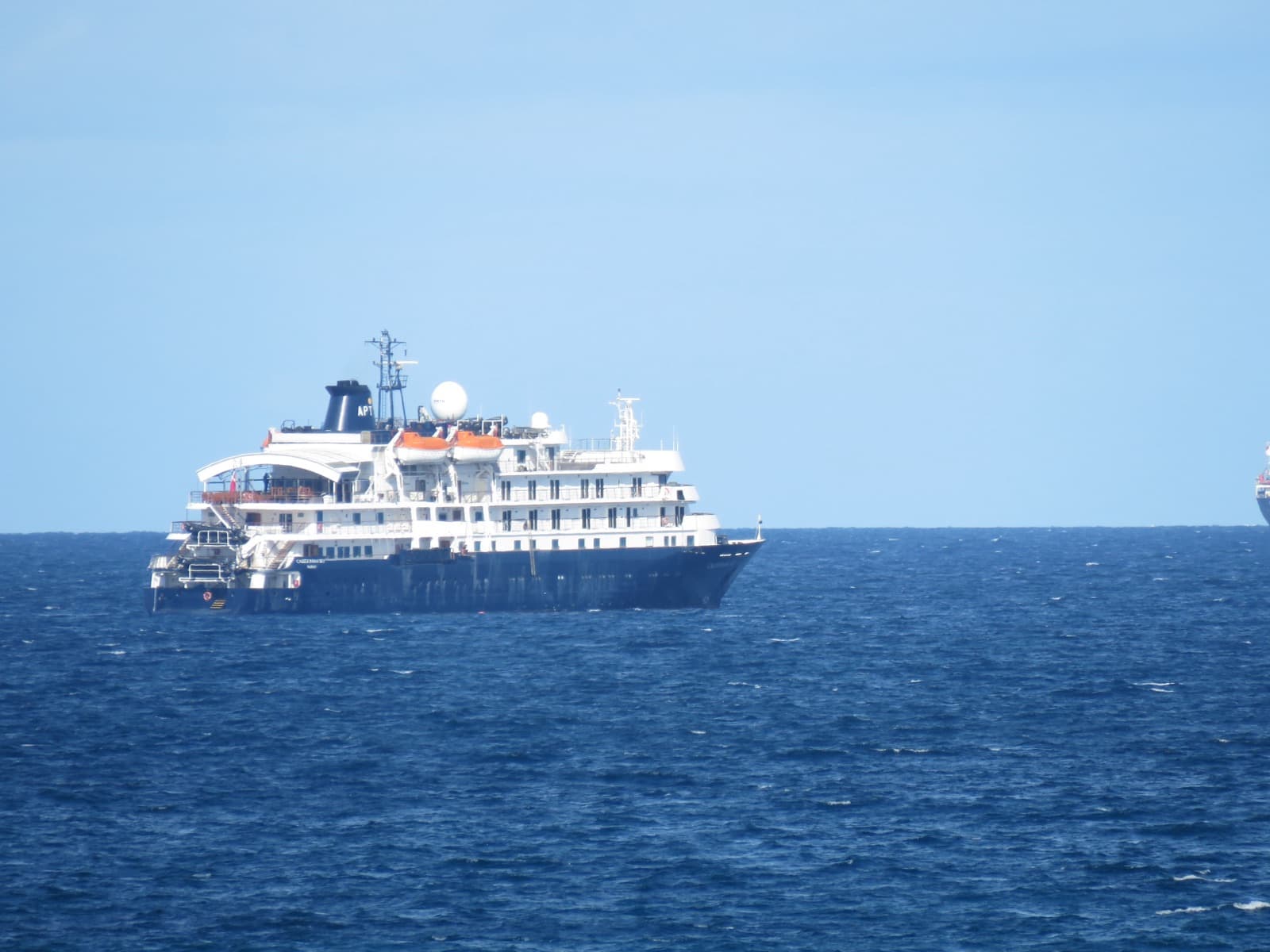 The small expedition ship now sailing as Blue Zephyr, at anchor off Fremantle in 2022 under her former name Caledonian Sky