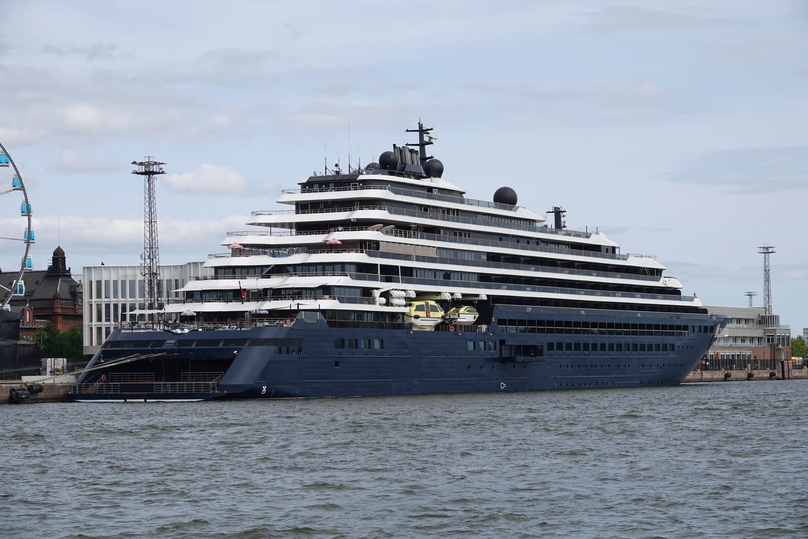 The Ritz-Carlton yacht Evrima at berth, her navy hull and tiered white decks in full profile