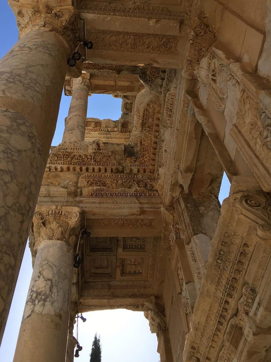 Carved coffered ceilings and marble columns of the Library of Celsus, seen from below