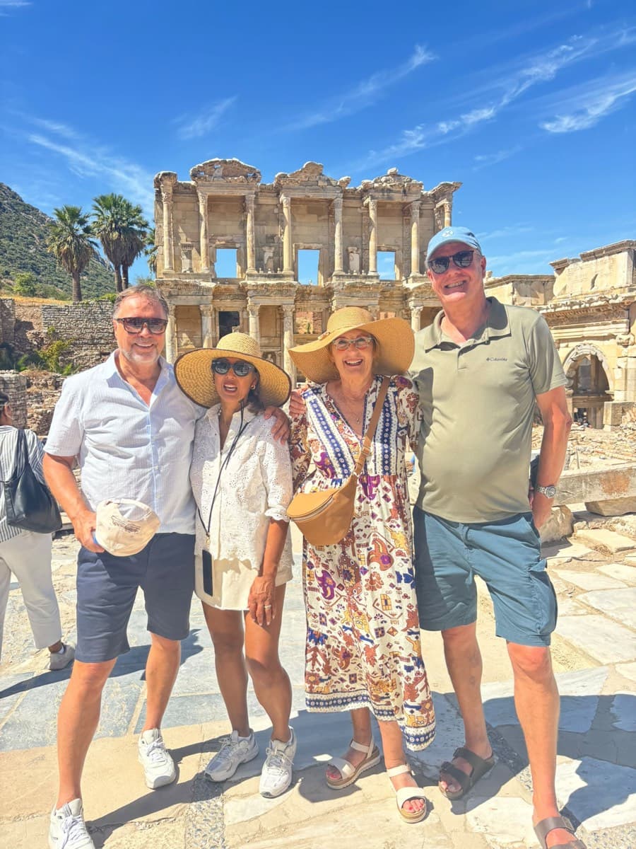 Four Celebrity Xcel guests in sun hats in front of the Library of Celsus, Ephesus, photographed by their Tours of Ephesus guide Gökhan Günaydın, 9 September 2026