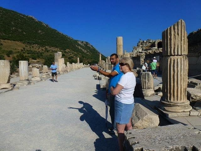 Licensed guide showing a guest the colonnaded marble street of Ephesus