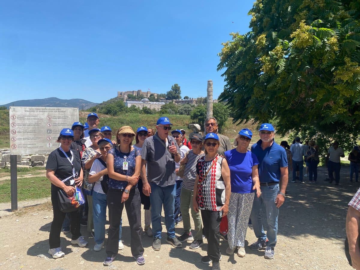 Guests at the Temple of Artemis near Ephesus, the single reconstructed column with Ayasuluk Castle on the hill behind