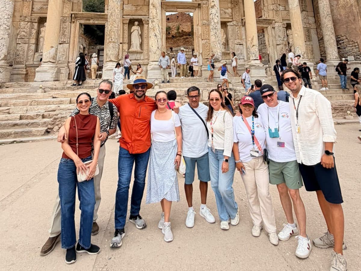 Guide Celal Ceylan, on the right in a white shirt, with a Mexican group ashore from Odyssey of the Seas in front of the Library of Celsus at Ephesus, on a private Ephesus, House of the Virgin Mary and Temple of Artemis tour guided in Spanish, 16 September 2026