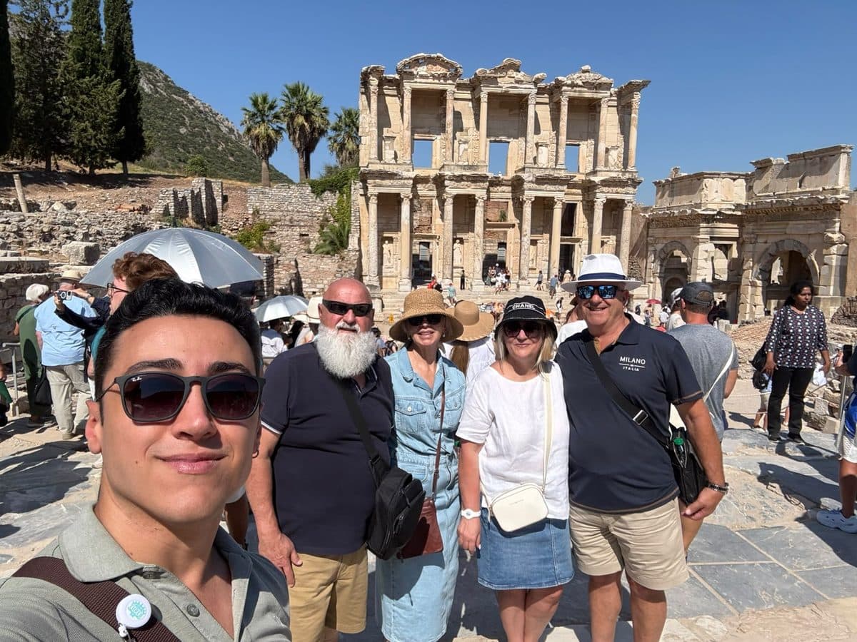 Tours of Ephesus guide Cem Yumuk in a selfie with four Sun Princess guests in front of the Library of Celsus, Ephesus, 20 August 2026
