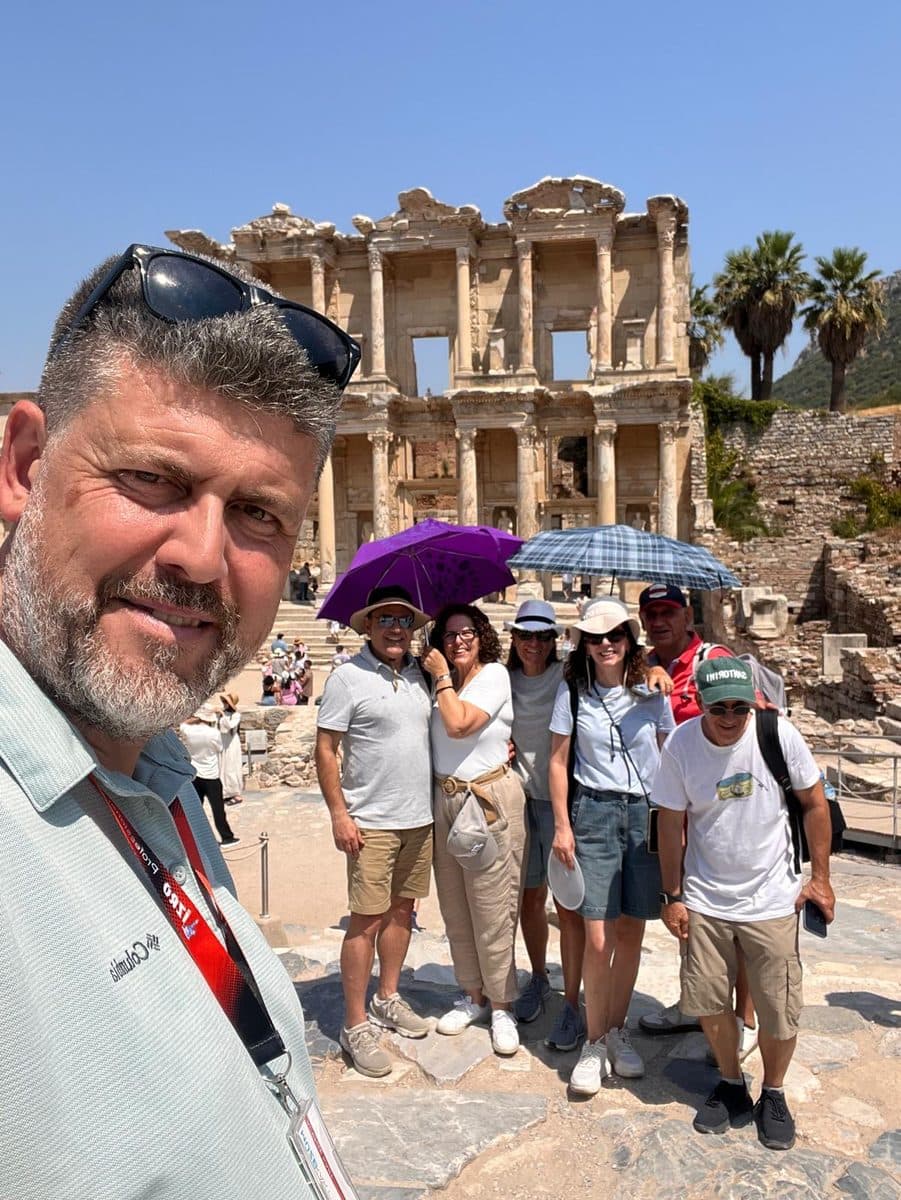 Tours of Ephesus guide Hakan Cebeci in a selfie with his Celebrity Xcel group before the Library of Celsus, Ephesus, 13 August 2026