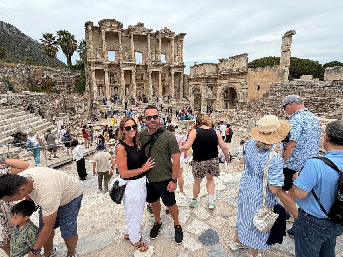 A couple from Royal Caribbean's Odyssey of the Seas on the marble street above the Library of Celsus and the Gate of Mazaeus and Mithridates at Ephesus, on a private Ephesus, House of the Virgin Mary and Temple of Artemis tour from Kuşadası cruise port, 16 September 2026