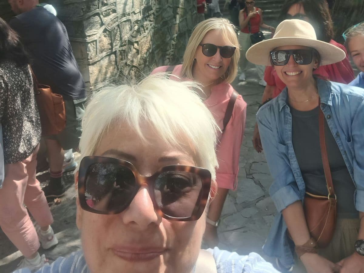 Licensed English-speaking guide Burçak Akdemir in a selfie with Odyssey of the Seas guests at the spring below the House of the Virgin Mary on Mount Koressos, on a private Ephesus, House of the Virgin Mary and Temple of Artemis tour from Kuşadası cruise port, 3 October 2026