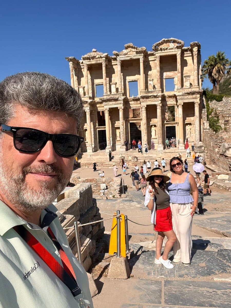 Our licensed guide Hakan Cebeci with two guests in front of the Library of Celsus during a private Ephesus tour from Kusadasi port, July 2026