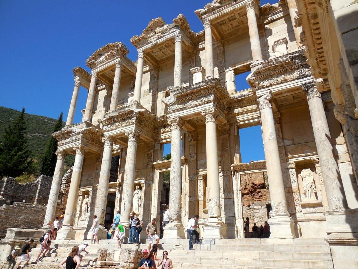 Visitors on the steps of the Library of Celsus on a sunny Ephesus morning