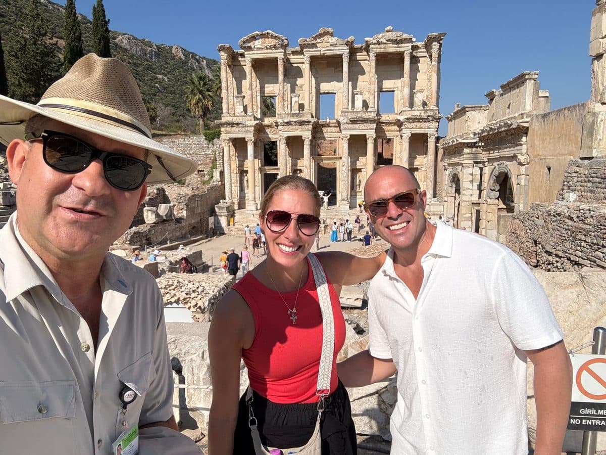 Two American guests from the Ritz-Carlton yacht Evrima with their licensed English- and Russian-speaking guide Mehmet Tunalı in front of the Library of Celsus on a private Ephesus tour in English from Kuşadası cruise port, 21 September 2026