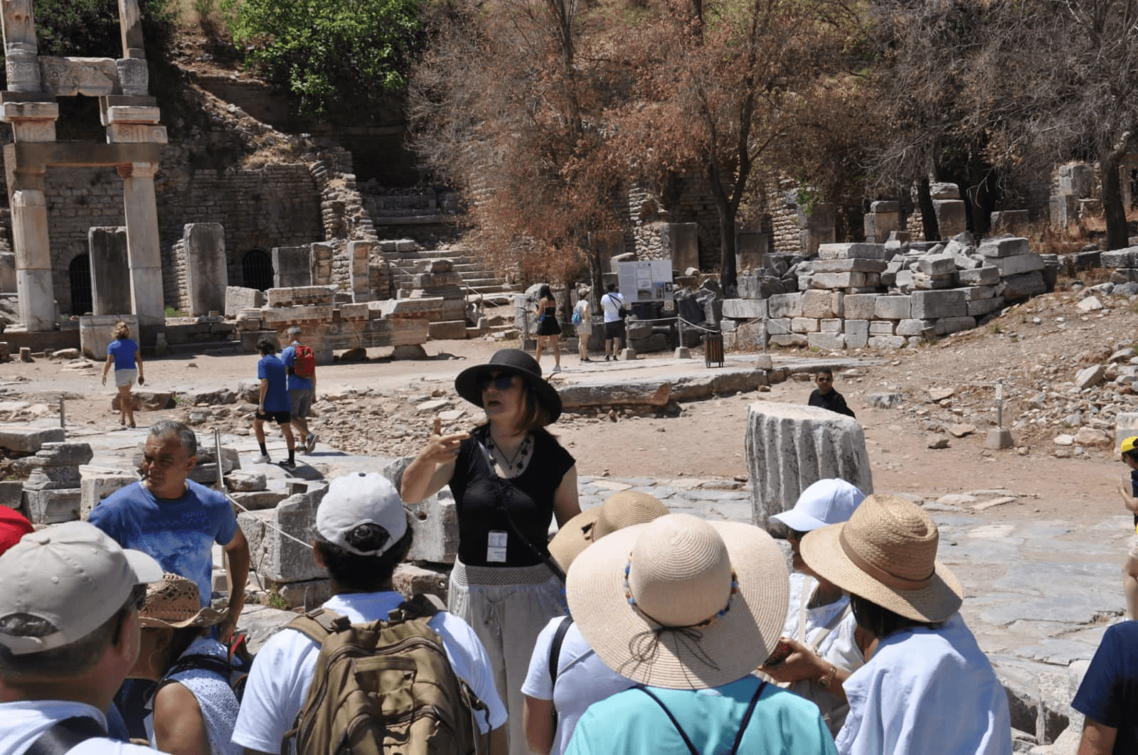 Licensed Ephesus guide explaining the Library of Celsus facade to a small private group on a quiet morning