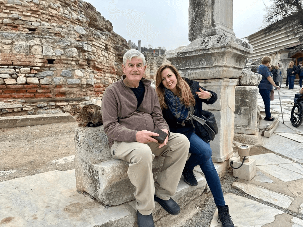 Older couple resting on a stone bench at Ephesus near the House of Virgin Mary