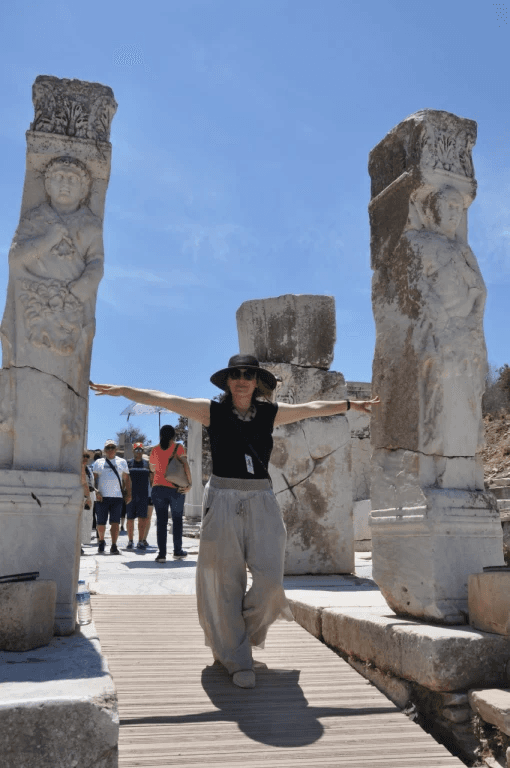 Solo guest taking in the carved column reliefs at Ephesus on a relaxed pace