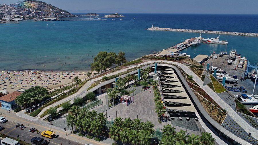 Aerial view of the newly opened Setur Marina Kuşadası with its curved promenade, sandy beach and rows of yacht slips, a twelve-minute walk from the cruise port